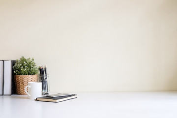 Wall Mural - Mockup workspace desk and copy space books,plant and coffee on white desk.