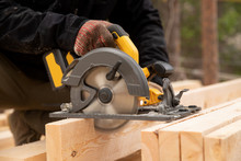 Builder Uses Portable Circular Saw Tool To Cut Wood