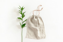 Ruscus Branch And Canvas Bag On White Background
