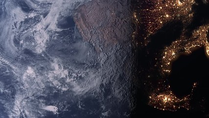 Wall Mural - planet earth slowly rotating revealing day to night concept with bright city lights over the west co