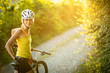 © lightpoet - Pretty, young woman biking on a mountain bike enjoying healthy active lifestyle outdoors in summer (shallow DOF)