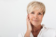 © Drobot Dean - Portrait closeup of beautiful adult woman with short blond hair wearing earpods
