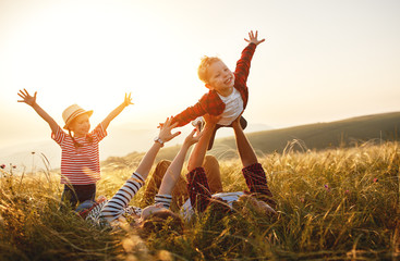happy family: mother, father, children son and daughter on sunset