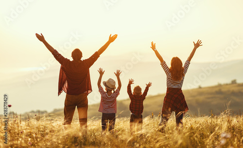 Happy family: mother, father, children son and daughter on sunset Poster Mural XXL