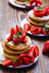 Wall Mural - Breakfast or brunch, pancakes with fresh summer strawberries, powdered sugar, honey