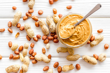 Wall Mural - peanut butter for cooking breakfast at home on white wooden background top view pattern