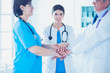 © lenets_tan - Group of doctors putting their hands together