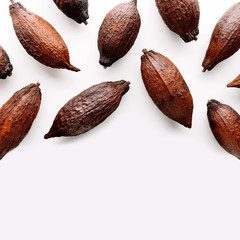 Cocoa pods on a white background, creative flat lay food concept