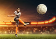 Soccer player kicks a ball. Night illuminated soccer stadium with dramatic sky
