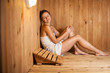 © lightpoet - Young woman relaxing in a sauna