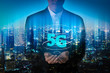 © Yingyaipumi - Double exposure image of Businessman hand holding 5g hologram and internet of things on city background. Business man creating 5g with his hand.