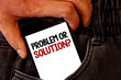 © Artur - Handwriting text Problem Or Solution Question. Concept meaning Think Solve Analysis Solving Conclusion Brown jeans back pocket hand pushing mobile phone with black and red text