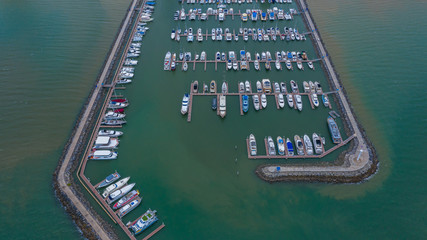 Canvas Print - Aerial view of yachts and boat berthed in the marina, Yacht parking, marina lot, Yacht and sailboat is moored at the quay.