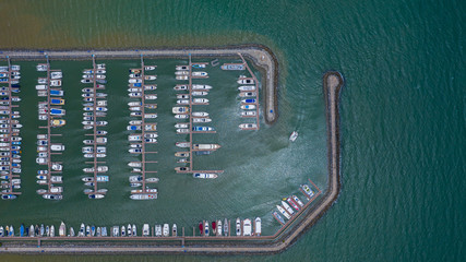 Canvas Print - Aerial view of yachts and boat berthed in the marina, Yacht parking, marina lot, Yacht and sailboat is moored at the quay.