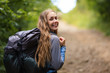 © Андрей Репетий - Happy hiking girl with backpack looking in camera. Traveling portrait of happy traveler.