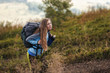 © Андрей Репетий - Young woman hiker hiking in beautiful mountains going along the trail in the mountains