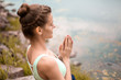 © Kate - Thin brunette girl plays sports and performs beautiful and sophisticated yoga poses in a summer park. Green forest and the river on the background. Woman doing exercises on the yoga mat. Lotus pose