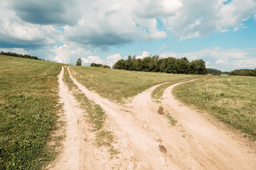 two rural road between fields