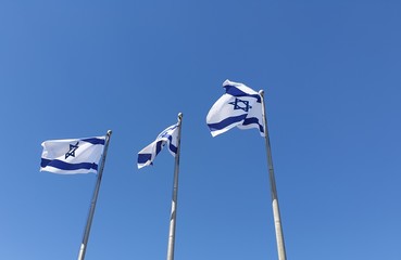 JERUSALEM, ISRAEL. August 13, 2019. A row of flags of Israel in front of the Israeli parliament Knesset. Israeli flags against the sky. Israel Independence Day concept.