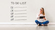© Tierney - To do list with young woman holding a tablet computer