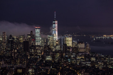 Fototapete - New York City skyline with lower Manhattan skyscrapers in storm at night.