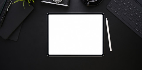 Wall Mural - Top view of blank screen tablet on black leather background