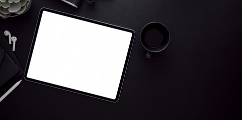 Blank screen tablet and coffee cup on black leather desk background i