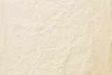 Old pale brown crumpled paper background texture