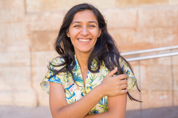 Young indian woman laughing in the street