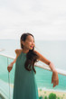 © siraphol - Beautiful portrait young asian woman happy smile relax at balcony with sea ocean