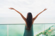 © siraphol - Beautiful portrait young asian woman happy smile relax at balcony with sea ocean