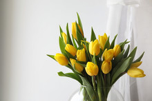 A Bouquet Of Yellow Tulips In A Vase On The Windowsill. A Gift To A Woman's Day From Yellow Tulip Flowers. Beautiful Yellow Flowers In A Vase By Window.
