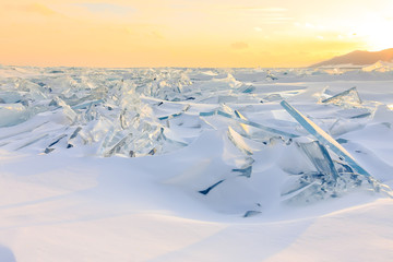 Wall Mural - Transparent blue Toros Baikal ice is shining through the crack sunset