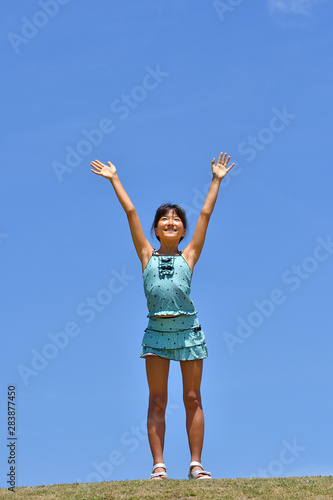 青空でバンザイする女の子 海水浴 水着 芝生広場 Buy This Stock Photo And Explore Similar Images At Adobe Stock Adobe Stock