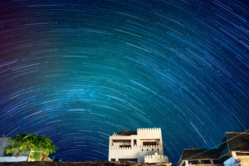 Star trails over exotic buildings