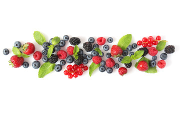 wild berries and mint leaves on a white background top view. blueberries, raspberries, strawberries, currants, blackberries