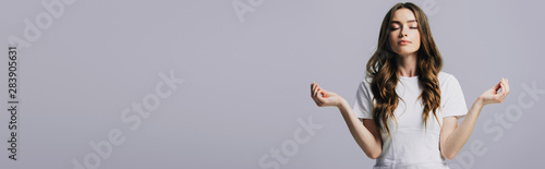 Fotografía beautiful girl in white t-shirt with closed eyes meditating isolated on grey, pa