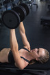 © wavebreak3 - Woman exercising with dumbbell in fitness center