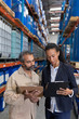 © wavebreak3 - Female manager and male worker discussing over clipboard in warehouse