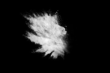 Wall Mural - freeze motion of white color powder exploding on dark background.