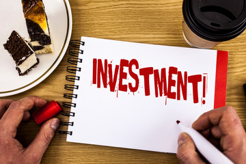 Conceptual hand writing showing Investment Motivational Call. Business photo showcasing To put Money Time into something to make profit written by Man Notebook wooden background Cake and Cup.