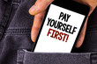 © A - Conceptual hand writing showing Pay Yourself First Motivational Call. Business photo text Personal Finance Save money for future written Mobile Phone holding by man the Jeans background.
