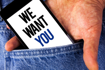 Writing note showing We Want You. Business photo showcasing Employee Help Wanted Workers Recruitment Headhunting Employment written Mobile phone screen holding by man the Jeans background.