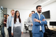 © NDABCREATIVITY - Portrait of handsome young businessman with his colleagues