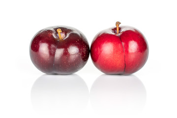 Group of two whole ripe red round plum isolated on white background