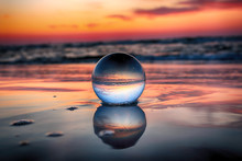 Beautiful Sunset On The Beach In Slowinski National Park Near Leba, Poland. View Of A Starfish Through A Glass, Crystal Ball (lensball) For Refraction Photography. Wild, Untouched Nature.