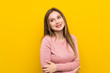 © luismolinero - Teenager girl over isolated yellow background laughing
