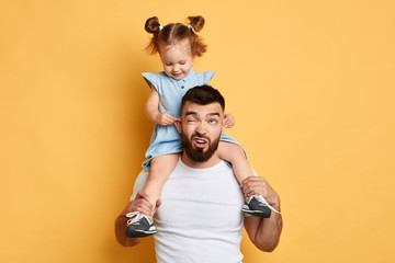 Wall Mural - daddy has been left one to sit with child and he cannot cope with it. kid got full control over situation.kid pulling her dad's ears