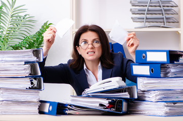 Middle-aged businesswoman unhappy with excessive work