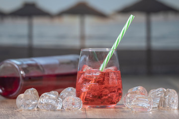 Fresh red water in glass, red water juice, red nectar quenches thirst, water is a mixture of red and sugar